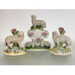 An assembled 19th century Staffordshire sheep model garniture of "clock" and pair of spill vases,