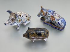 A slipware pig money bank, 19th century, part in a spatter marbled glaze; a Delft model of a