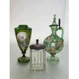 A group of Bohemian glass comprising: a green glass ring decanter, enamel painted with scrolling