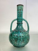 The Bombay School of Art Pottery: a twin-handled vase in the Persian taste, c. 1900, with foliate