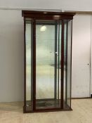 A late 19th century mahogany framed glazed shop cabinet, the projecting cornice over a full length