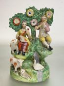 A Staffordshire bocage group, early 19th century, of a male and female musician, with animals at