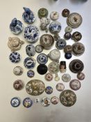 A large group of Chinese and Continental porcelain and other ceramic covers and stands (a