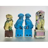 A pair of Chinese turquoise-glazed models of lion dogs, 20th century, each in characteristic pose