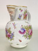 A Meissen jug with mask spout and moulded cabbage leaf body, painted with floral sprays,