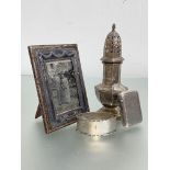 A group of silver comprising: a small silver-mounted leather photograph frame, Birmingham 1906; an