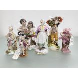 A Derby porcelain figure of a boy carrying a bunch of faggots, c. 1800; together with a group of