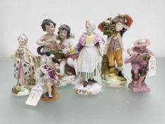 A Derby porcelain figure of a boy carrying a bunch of faggots, c. 1800; together with a group of