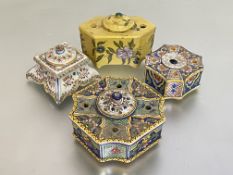 A group of four faience inkwells, 19th century and later, of varying designs, one yellow painted
