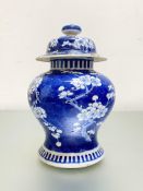 A Chinese blue and white porcelain vase and cover, decorated with prunus, four character mark of