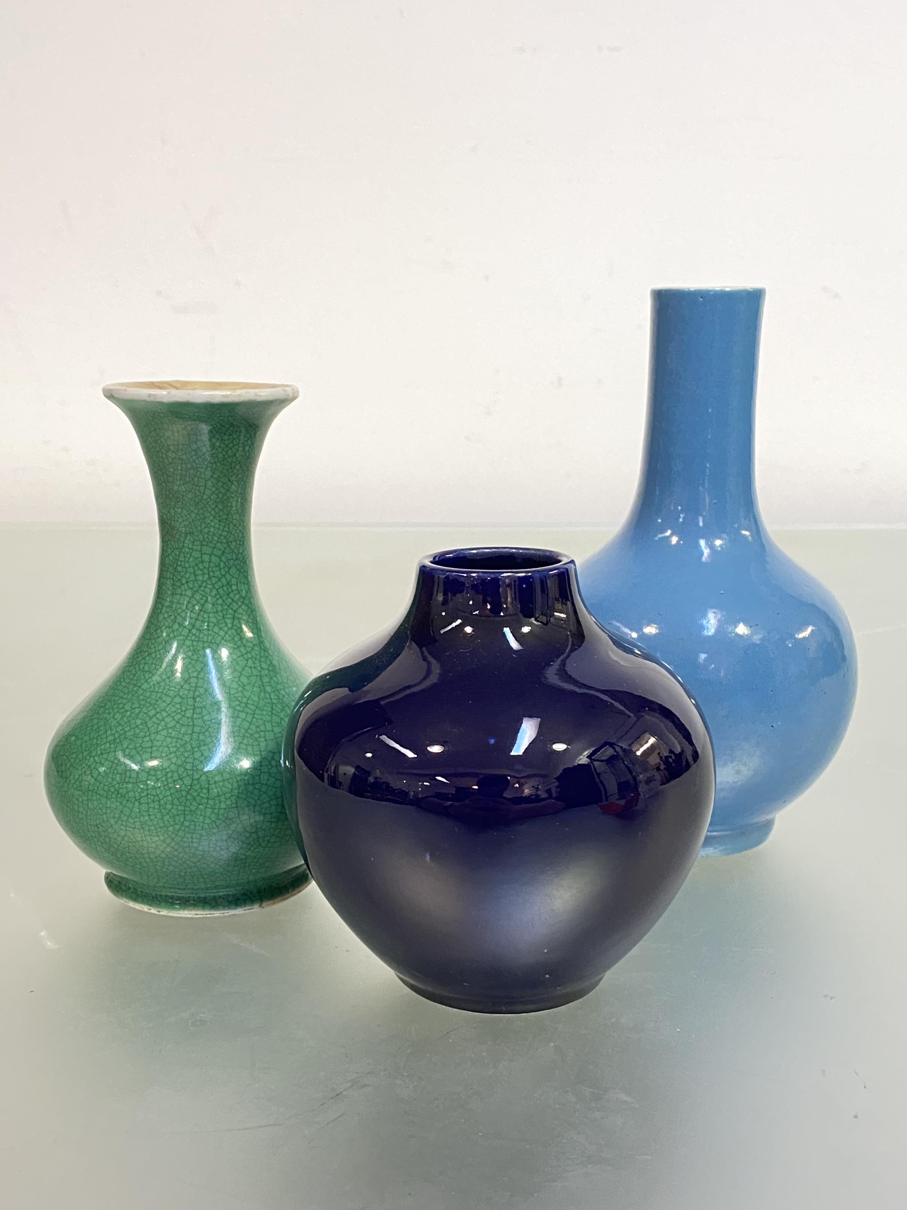 A group of three small Chinese porcelain vases comprising: a clair-de-lune monochrome glazed