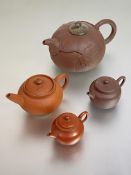 A Chinese Yixing red stoneware teapot modelled as a pumpkin with leaves in relief and with (possibly