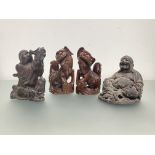 A group of four Chinese wooden carvings: a pair of lion dogs, each with glass eyes, modelled seated;