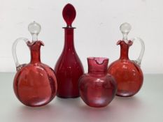 A group of 19th century and later ruby and cranberry glass comprising: a pair of ribbed decanters,