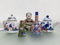 Two small Chinese fluted porcelain teapots, each decorated with figures in an Imari palette: