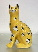 A Griselda Hill Pottery (Wemyss) model of a Galle style cat, glazed in yellow and with glass eyes,
