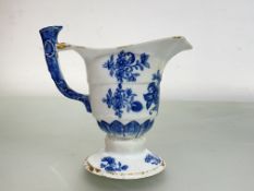 A Chinese Export blue and white porcelain jug of helmet shape, 18th century, decorated with floral