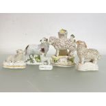A group of 19th century Staffordshire models of sheep, including a spill vase, with sheep and lamb