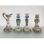 A group of French faience candlesticks comprising: a pair, of flattened baluster form, on square