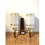 A mid century twin branch teak and brass wall sconce, circa 1950-1960, with cylindrical opaline