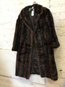 A fur coat measures 33cm across shoulders x 93cm