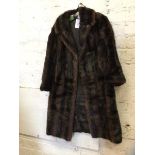 A fur coat measures 33cm across shoulders x 93cm