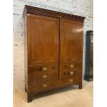 A Georgian mahogany cupboard, the dentil cornice over strung frieze with conch paterea, the twin