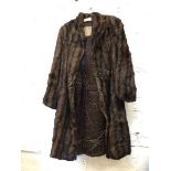 A fur coat labelled to interior Alexander Miller ? Edinburgh, measures 34cm across shoulders x