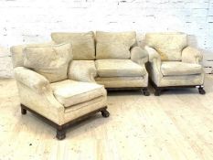 An early to mid 20th century mahogany framed three piece lounge suite, comprising a two seat sofa in