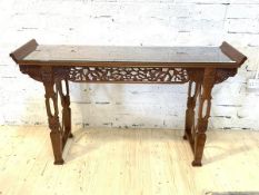 A Chinese hardwood alter table, with plate glass top, pierced frize, raised on four shaped supports,