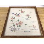 A 1930's / 40's embroidered panel depicting a bird on a branch, measures 51cm x 45cm verso with