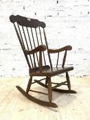 A stained plywood and beech farmhouse style rocking chair, some spindles loose H104cm