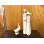 A Lladro figural group of two nuns measures 33cm high and a Nao figure of a duck (2)