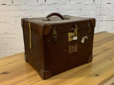 An early 20th century Pukka Luggage studded and leather bound travelling suitcase, with carry handle