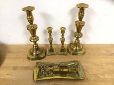 A pair of brass candlesticks of baluster form each measures 25cm high and another smaller pair, a