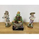 A Royal Doulton figure The Cobbler measures 22cm high along with two German figures of a boy and