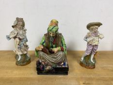 A Royal Doulton figure The Cobbler measures 22cm high along with two German figures of a boy and