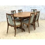 G-Plan, A mid century teak extending dining table, the oval top concealing a magic leaf, raised on