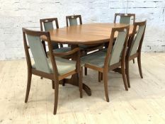 G-Plan, A mid century teak extending dining table, the oval top concealing a magic leaf, raised on