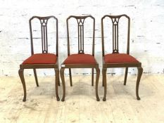 A Set of three early 20th century mahogany dining chairs, with pierced plat, drop in seat pads,