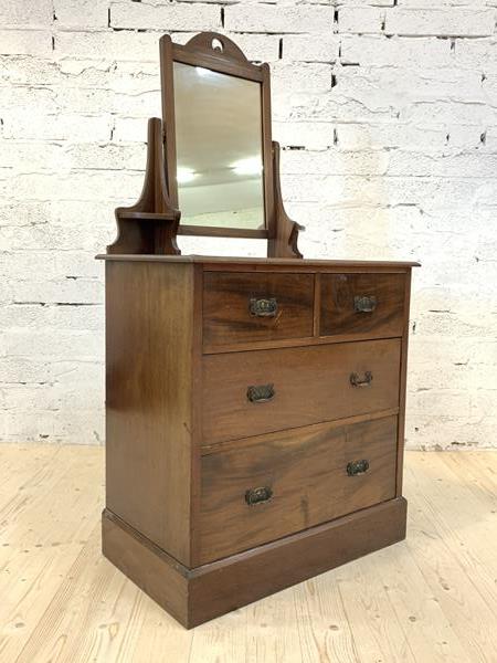 An early 20th century mahogany dressing chest, the swing mirror over two short and two long