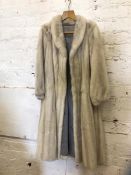 A mink fur coat, measures 37cm across the shoulders x 116cm, along with a hat and two cuffs