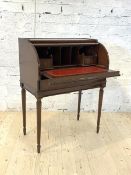 A late 20th century inlaid mahogany bureau, the cylinder top lifting to reveal a tooled red