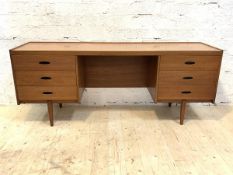 A mid century teak dressing table, fitted with six drawers, raised on square tapered supports,