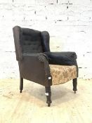 A Mid 19th century mahogany framed fireside wing back armchair, in studded upholstery, with carved