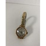 A 1930's ladies wrist watch interior case marked Chester 9ct gold on a rolled gold strap, dial