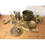 A quantity of brassware including a footed pot measuring 13cm high, a bell, candlesticks, ash