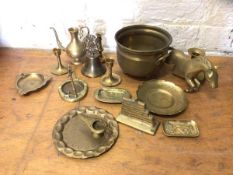 A quantity of brassware including a footed pot measuring 13cm high, a bell, candlesticks, ash