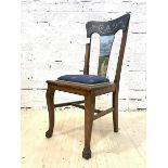 An early 20th century oak side chair, the shaped crest rail over splat painted with rural landscape,