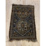 A Hand knotted Persian rug, the field with geometric design enclosed by a border with guard stripes,
